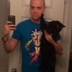 Adam wearing "By Moonlight" shirt with Luna the cat