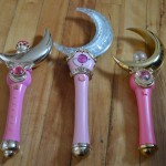 Irwin Cosmic Crescent Wand (left) Live Action Sailor Moon Moon Stick (center) Bandai Proplica Moon Stick (right)