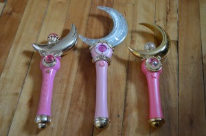 Irwin Cosmic Crescent Wand (left) Live Action Sailor Moon Moon Stick (center) Bandai Proplica Moon Stick (right)