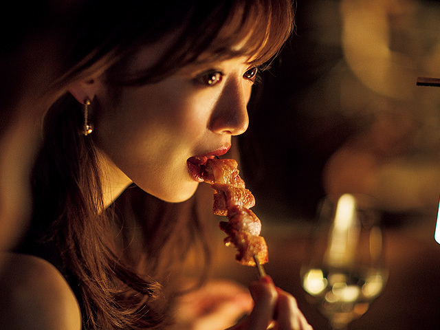 Rika Izumi eats a piece of bacon